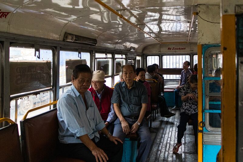 Members of the Chinese Indian community board the bus which will take them to Achipur. All Photos: Puja Bhattacharjee for The National