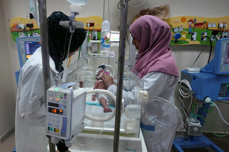 Palestinian doctors treat a premature baby at Al Aqsa Hospital in Deir Al Balah, Gaza. AP