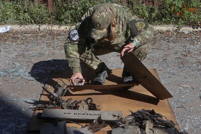 A police officer in Kharkiv inspects the remains of a suspected Shahed-136 attack drone fired at Ukraine. Reuters 