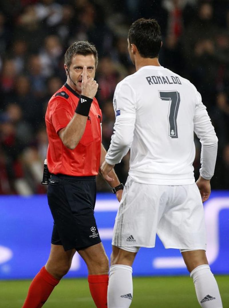 Referee Nicola Rizzoli warns Cristiano Ronaldo on Wednseday night during the Champions League match against Paris Saint-Germain in France. Yoan Valat / EPA