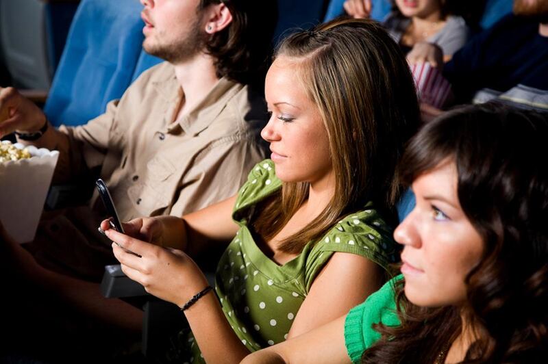 Readers urge moviegoers to keep all mobile phone use until after the film. iStockphoto

