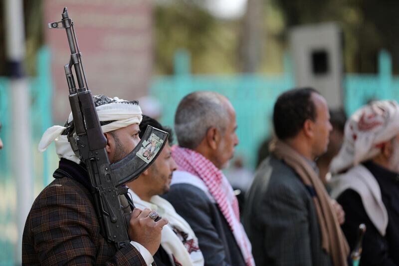 A Houthi supporter holds a rifle as he attends a ceremony held to send donated clothes to Houthi fighters at the frontlines against government forces, in Sanaa, Yemen November 24, 2020. REUTERS/Khaled Abdullah