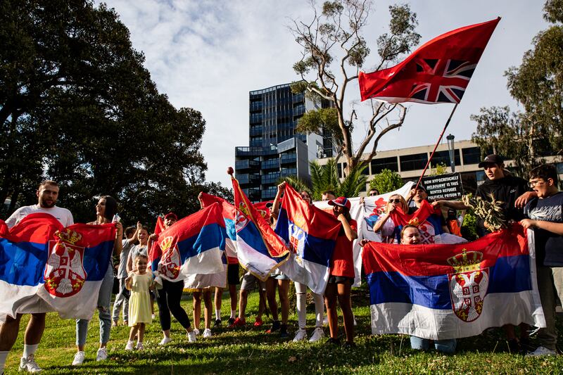 Supporters of Novak Djokovic hold Serbian flags outside a hotel in Melbourne where the tennis star was taken pending a verdict on his potential deportation. Getty