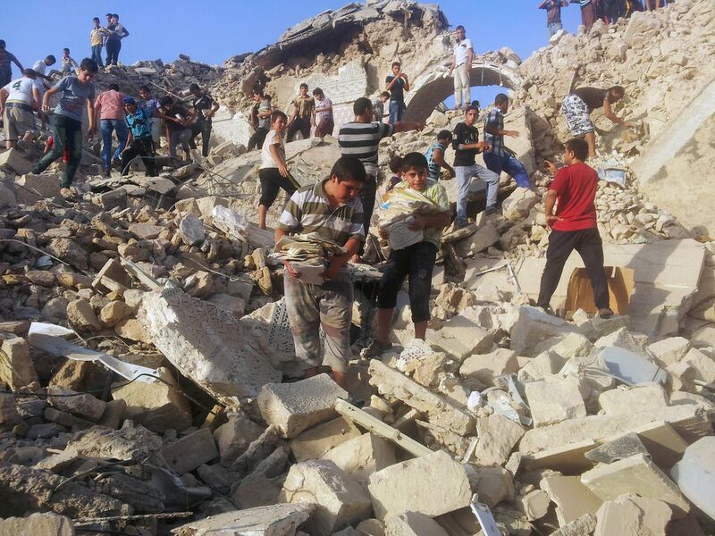 People pick through the rubble of the destroyed Mosque of The Prophet Younis, or Jonah, in Mosul, Iraq, on July 24, 2014. The revered Muslim shrine was destroyed by militants who overran the city in June and imposed their harsh interpretation of Islamic law. The mosque was built on an archaeological site dating back to 8th century BC, and is said to be the burial place of the prophet, who in stories from the Bible and Quran is swallowed by a whale. Associated Press, file