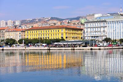 Rijeka, Croatia - March 23, 2012: view of the promenade with bars and people walking. Getty Images