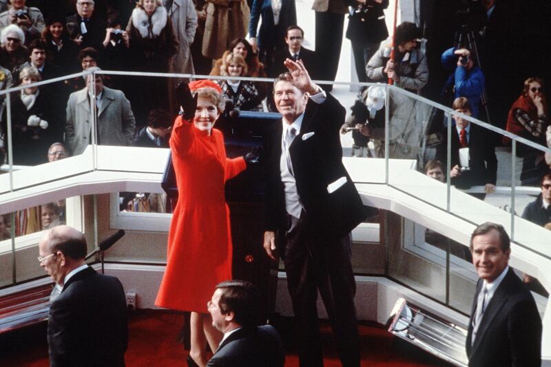 US President Ronald Reagan (C) salutes beside his wife Nancy Reagan after being sworn in as 40th President of the United States by Chief Justice Warren Burger during inaugural ceremony, on January 20, 1981 at the Capitol in Washington, DC. At right is vice-president George W. Bush. (Photo by CONSOLIDATED NEWS PICTURES / AFP)