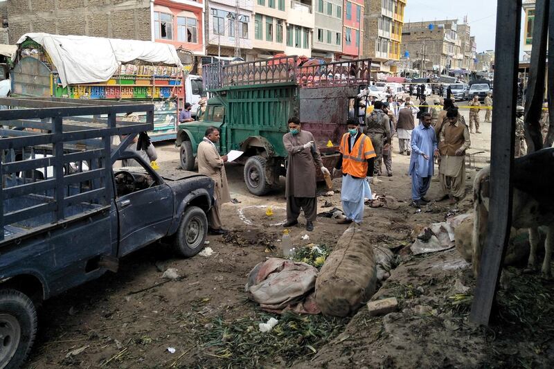 Members of the bomb disposal unit survey the site after a blast at a vegetable market in Quetta, Pakistan April 12, 2019. REUTERS/Naseer Ahmed