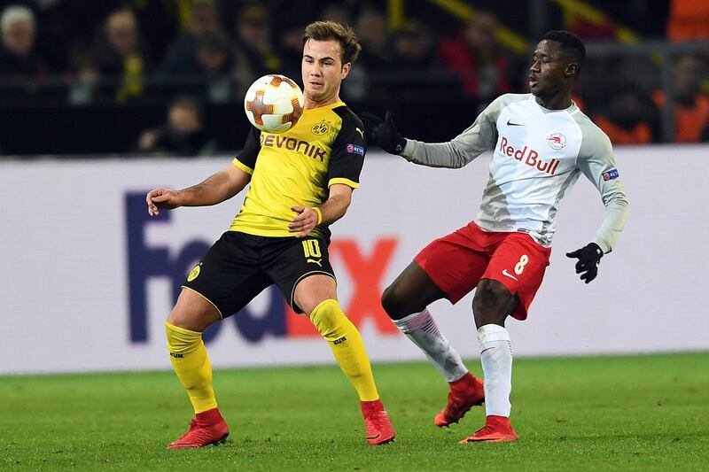 Dortmund's German midfielder Mario Goetze (L) and Salzburg's midfielder from Mali Diadie Samassekou vie for the ball during the Europa League Round of 16 first leg football match between Borussia Dortmund and FC Salzburg on March 8, 2018 in Dortmund. / AFP PHOTO / DPA / Federico Gambarini / Germany OUT