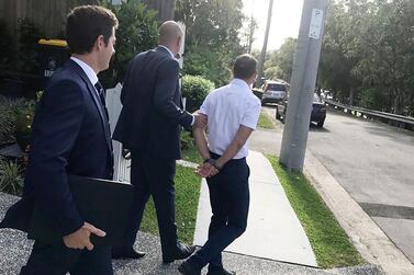Officers arrested Russell Waugh from his Brisbane home on Wednesday before he was charged with foreign bribery. Photo provided by the Australian Federal Police