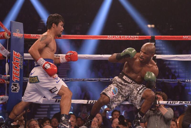 Bradley, losing balance here, was knocked back a few times by Pacquaio. Joe Klamar / AFP