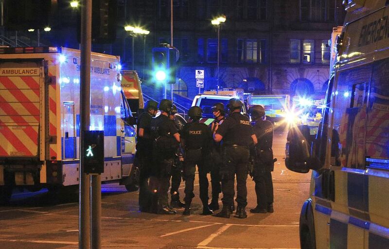 Armed police gather at Manchester Arena after the explosion. PA/AP