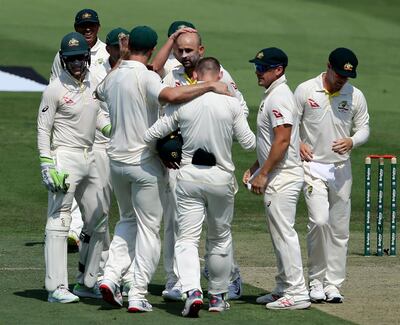 Australia's Nathan Lyon, center, celebrates the dismissal of Pakistan's Azhar Ali with teammates during their test match in Abu Dhabi, United Arab Emirates, Tuesday, Oct. 16, 2018. (AP Photo/Kamran Jebreili)