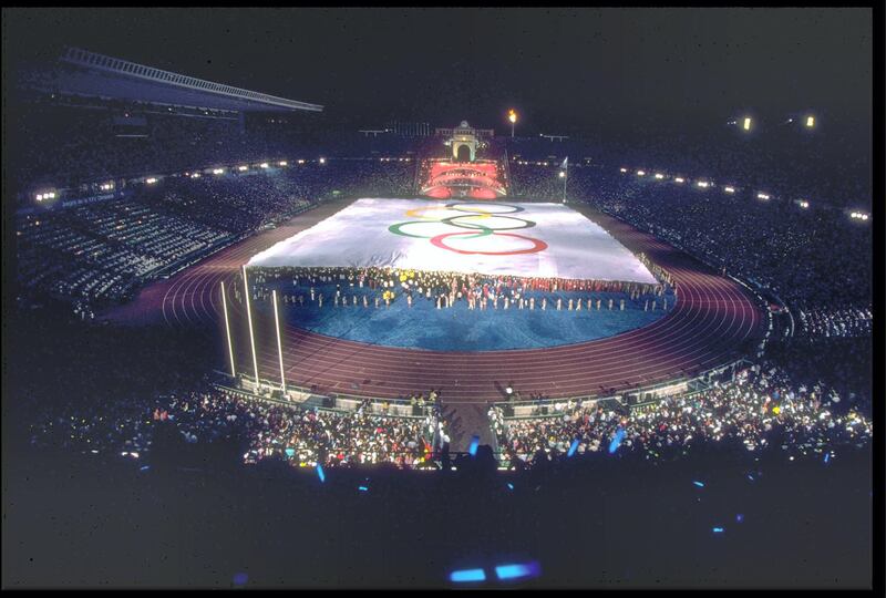 25 JUL 1992:  A GIANT OLYMPIC FLAG IS PULLED ACROSS THE FIELD INSIDE THE OLYMPIC STADIUM DURING THE OPENING CEREMONY OF THE 1992 BARCELONA OLYMPICS.