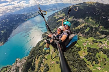 Paragliding in Interlaken means soaring over glacial lakes and alpine scenery. Photo: Skywings Paragliding