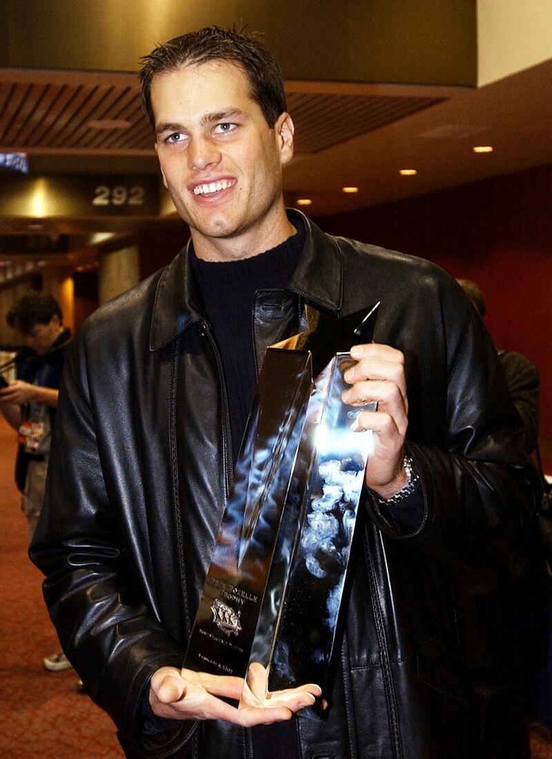Tom Brady holds the Most Valuable Player award for Super Bowl XXVI in New Orleans, the US, on February 4, 2002. AFP