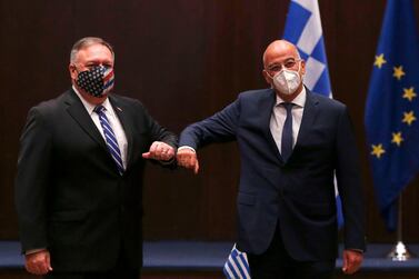 US Secretary of State Mike Pompeo (L) and Greek Foreign Minister Nikos Dendias touch elbows during their meeting in the northern city of Thessaloniki, on September 28, 2020. AFP
