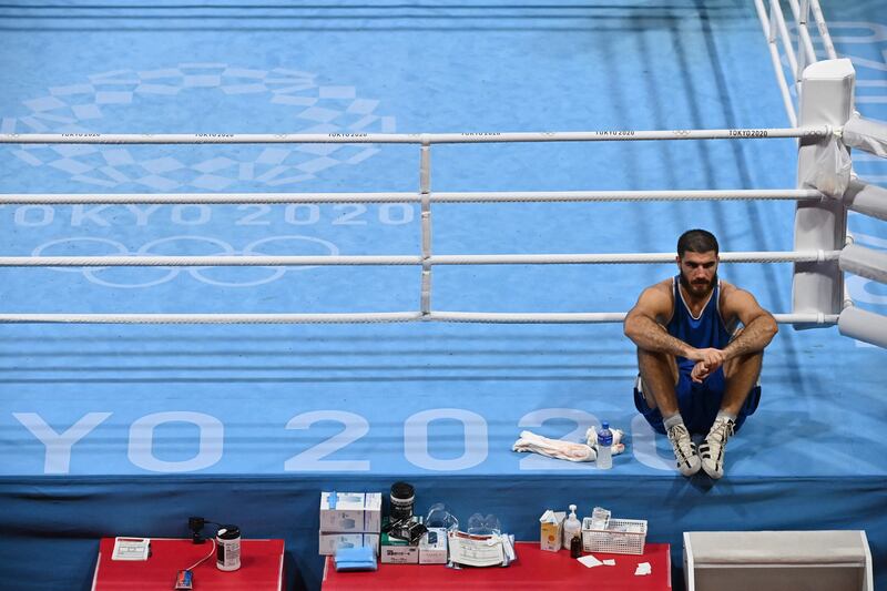 France's Mourad Aliev waits outside the ring after losing by disqualification.