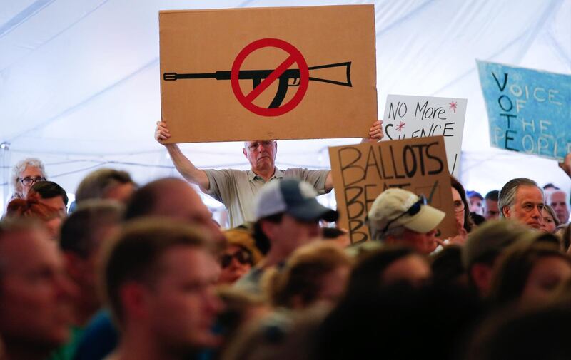 A man displays an anti gun violence sign during a March for our Lives Rally at Fairfield Hills Campus, in Newtown Connecticut on August 11, 2018. (Photo by KENA BETANCUR / AFP)