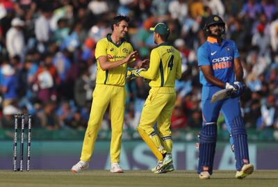 Australia's Pat Cummins, left, celebrates with teammate Alex Carey, center, the dismissal of India's Vijay Shankar, right, during the fourth one day international cricket match between India and Australia in Mohali, India, Sunday, March 10, 2019. (AP Photo/Altaf Qadri)