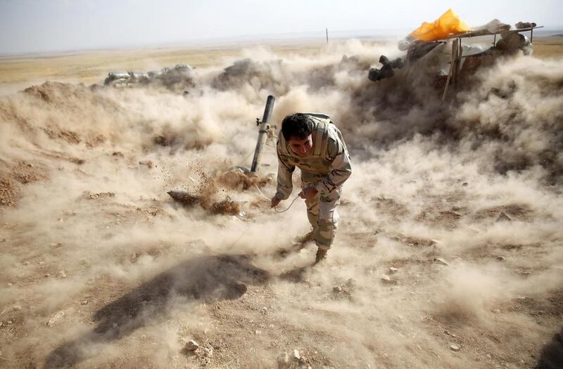 A Kurdish Peshmerga fighter launches mortar shells towards ISIL positions on September 15, 2014. Ahmed Jadallah/Reuters
