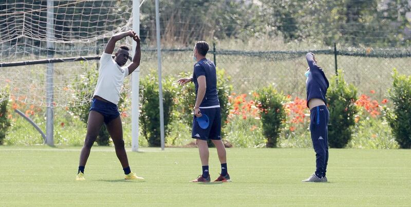 Mario Balotelli and fellow Bresica players stretch during a training session. EPA