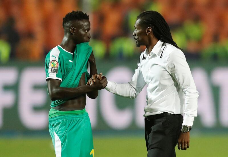 Senegal manager Aliou Cisse consoles Ismaila Sarr on his side's loss. Reuters