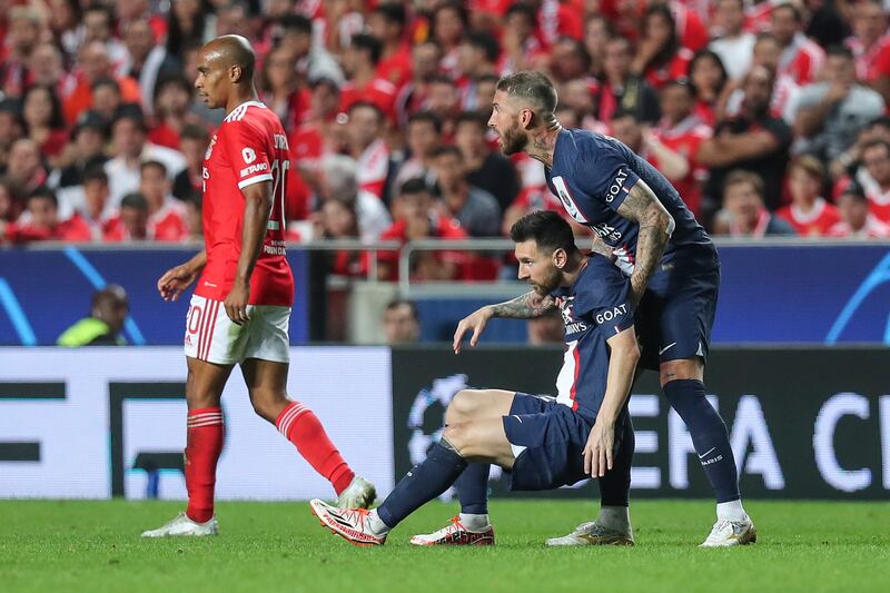 Paris Saint Germain's Sergio Ramos helps up team-mate Lionel Messi. EPA