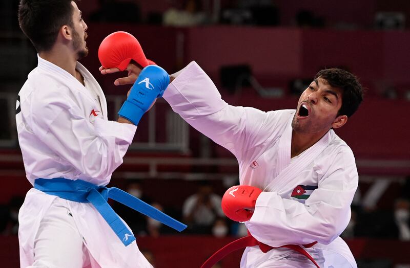 Turkish karate star Eray Samdan (L), who won silver, competes against Jordan's Abdel Rahman Almasatfa, who won bronze in the men's kumite 67kg in Tokyo.