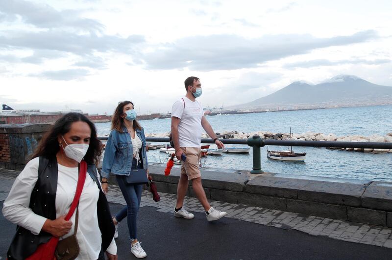 People wear face masks after the southern Italian region of Campania made it mandatory to wear protective face coverings outdoors in Naples, Italy. Reuters
