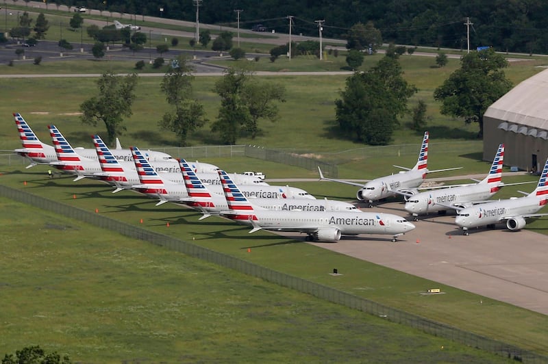 FILE - In this May 24, 2019, file photo, grounded Boeing 737 Max jets belonging to American Airlines are stored at Tulsa International Airport in Tulsa, Okla. American Airlines said Thursday, Jan. 2, 2020, it is negotiating with Boeing over compensation for the airline's grounded planes and will share some of the proceeds with its employees. (Tom Gilbert/Tulsa World via AP, File)