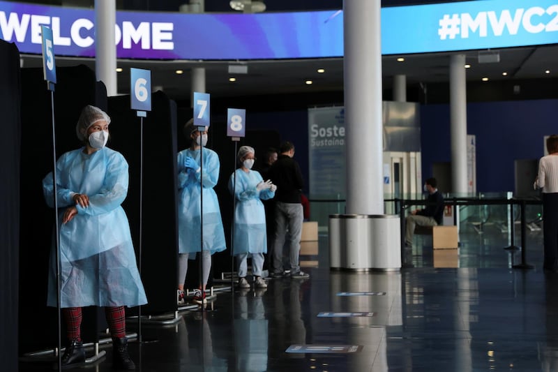 Workers wait to collect a coronavirus disease swab sample in the Fira of Barcelona, Spain. Reuters