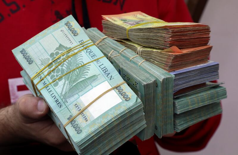 A money exchanger displays Lebanese pound notes at his shop in Beirut, Lebanon. Reuters