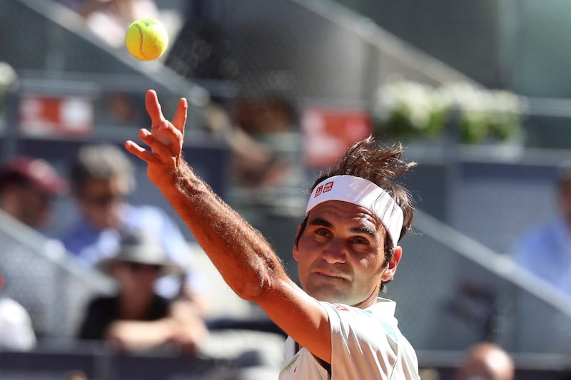 Federer keeps his eye on the ball as he serves. EPA