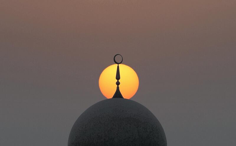 Abu Dhabi, United Arab Emirates - May 31st, 2018: Standalone. The sun sets over a mosque during Ramadan. Thursday, May 31st, 2018 at Al Bahya, Abu Dhabi. Chris Whiteoak / The National