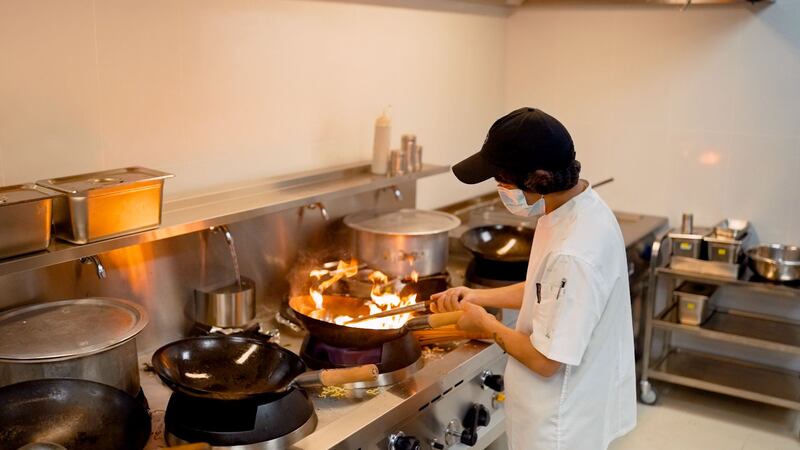 A cook prepares a meal at Deliveroo's new dark kitchen facility in Dubai. Courtesy: Deliveroo.