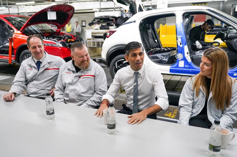 Britain's PM Rishi Sunak on the Nissan Juke production line in Sunderland earlier this year. He described the latest move as 'a pragmatic solution to keep costs down'. AFP