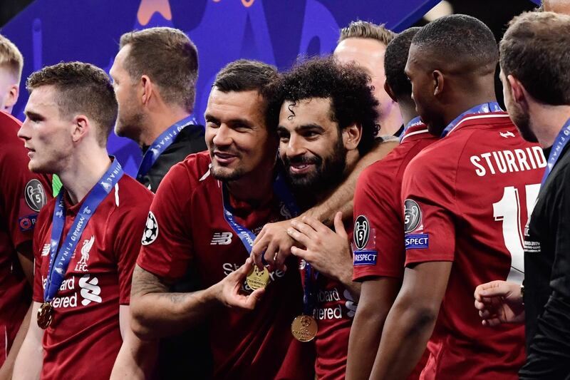 Salah is embraced by teammate Dejan Lovren. AFP Photo