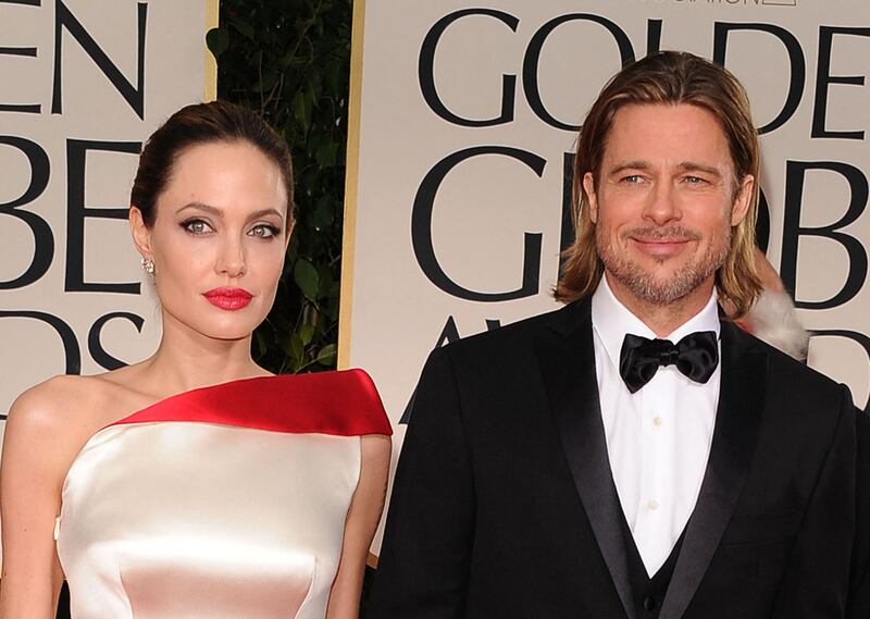 Brad Pitt allegedly hit one of his children in the face and choked another during a fight with Angelina Jolie on a private plane, according to court papers filed by his ex-wife. Getty Images / AFP