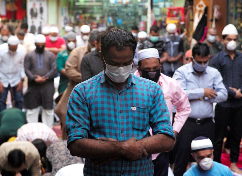 Muslims wear protective face masks following the coronavirus outbreak, as they pray on a street during Friday prayers in local souq, in Manama, Bahrain, February 28, 2020. REUTERS/Hamad I Mohammed