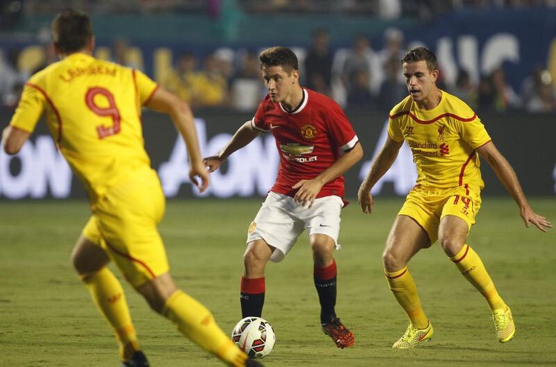 Liverpool’s Rickie Lambert, left, defends as Manchester United’s Ander Herrera moves with the ball as Liverpool’s Jordan Henderson, right, looks on during the first half of the Guinness international Champions Cup championship game at SunLife Stadium in Miami, Florida, USA on August 4, 2014. EPA/ANDREW INNERARITY