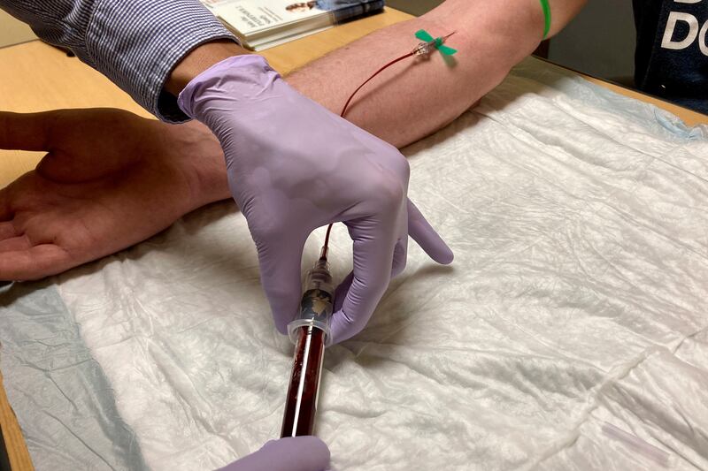 A medical worker draws blood as part of new liquid biopsy technology that could detect early signs of cancer in the blood. AP