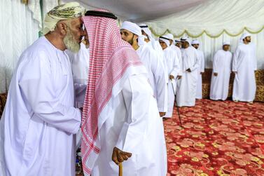 Mourners visit the Al Katheeri family at a tent to offer condolences. They enter as families. Victor Besa/The National 