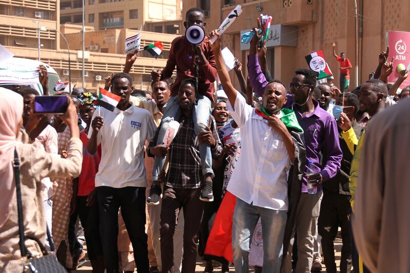 Protesters chant 'one army, one people' and 'the army will bring us bread' slogans during their demonstration outside the presidential palace in Khartoum. AP
