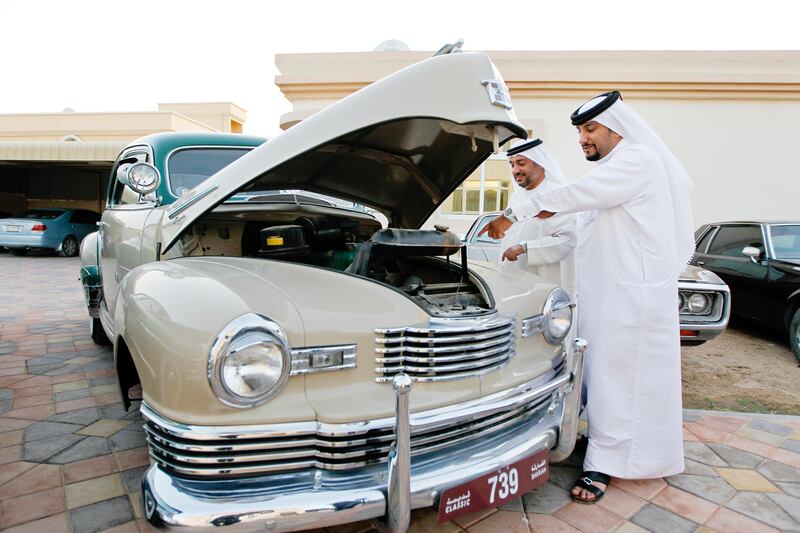 Sharjah, May 9, 2013 - (L to R) Brothers Jasim Mubarak and Faisal Mubarak discuss an engine block and their family's classic car "garage" in Sharjah, May 9, 2013.(Photo by: Sarah Dea/The National)

