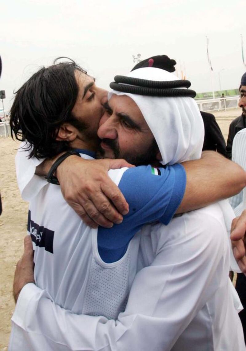 Sheikh Rashid hugs his father after winning a horse race.