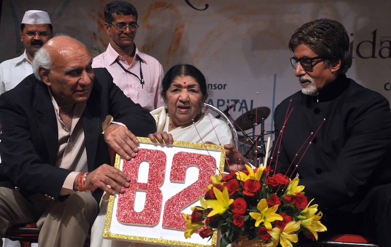 Mangeshkar, centre, with Bollywood actor Amitabh Bachchan, right, and producer and director Yash Chopra during celebrations for her 82nd birthday in Mumbai on September 28, 2011. AFP