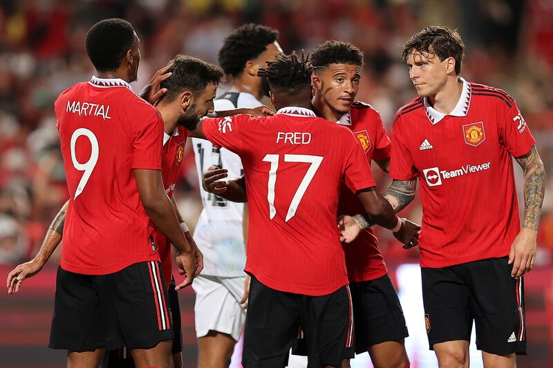 Jadon Sancho, second right, celebrates with his Manchester United teammates after scoring their first goal against Liverpool. Getty 