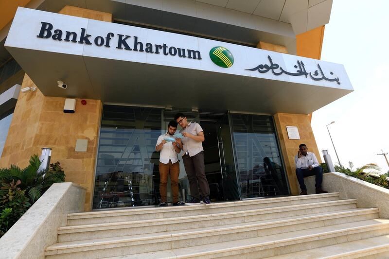 FILE PHOTO: Customers wait outside the Bank of Khartoum, in Khartoum, Sudan September 11,2017. REUTERS/Mohamed Nureldin Abdallah/File Photo