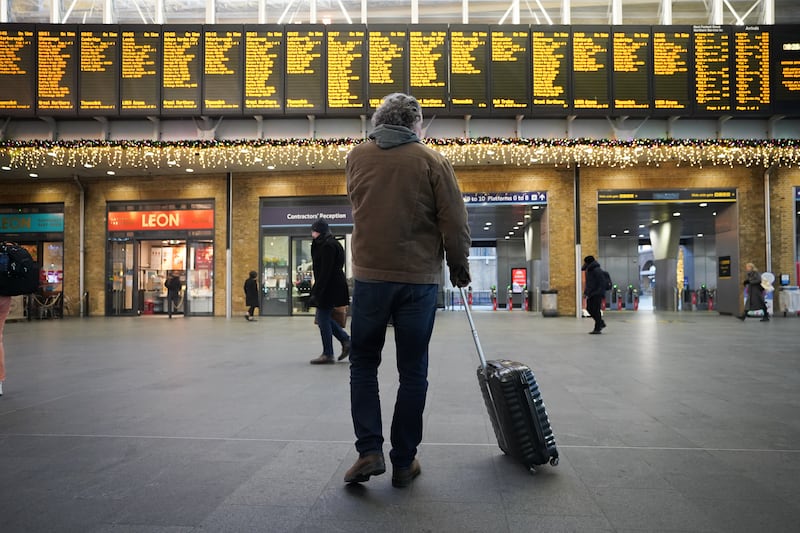 Passengers view departure boards at Kings Cross station in London on Wednesday, during a strike by the Rail, Maritime and Transport union. PA