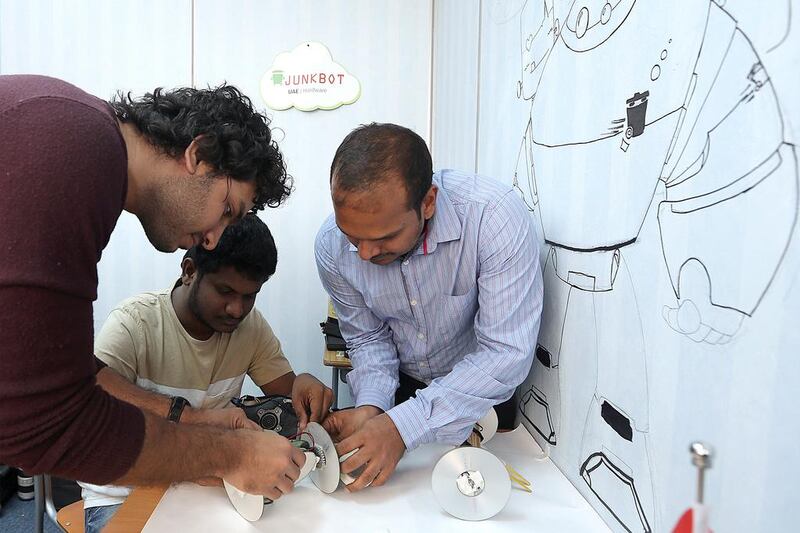 Ehteshamuddin PA, the chief executive of Junkbot, left, and his team work on a robot. Satish Kumar / The National